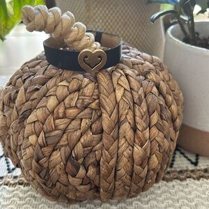 O.J. Perrin bracelet legendes, yellow gold on blk leather band. Bought in Paris.